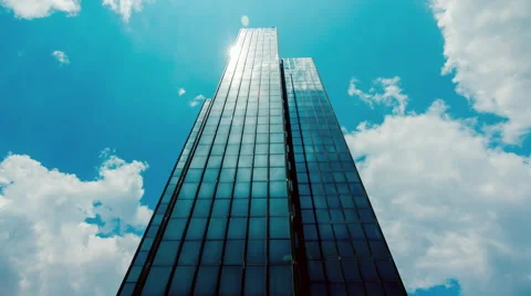 Huge Glass skyscraper sunrays and clouds reflection timelapse 25p Stock Footage 50543639