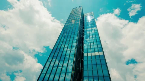 Huge Glass skyscraper sunrays and clouds reflection timelapse 30p Stock Footage 50548714