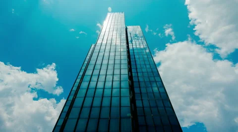Huge Glass skyscraper sunrays and clouds reflection timelapse 30p Stock Footage 50548823