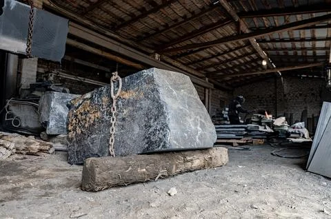 Huge granite stone in a stone processing factory. Stone cutting Stock Photos
