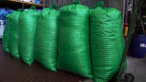 Huge green bags full of down in the  in the down manufacturing factory Vídeos de archivo 73737982