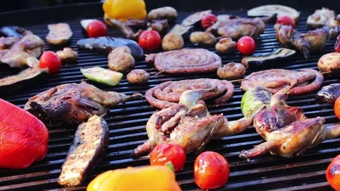 A huge grill on which aesthetically laid out roasted sausages, sweet peppers Stock Footage