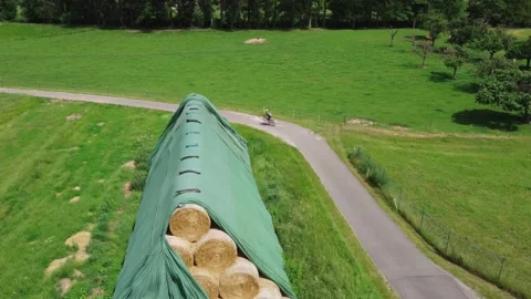 A huge haystack passing by a cyclist Stock Footage 155892867