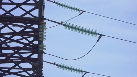 Huge high-voltage electrical pylons against a blue sky close-up Stock Footage 105637105