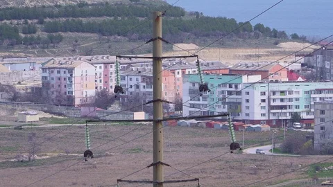 Huge high-voltage electrical supports, wires with electricity lead to the city c Stock Footage 105637751