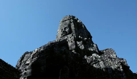 A huge human face built of stone blocks. Huge human faces on the towers Stock Photos