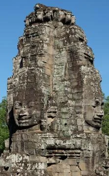 A huge human face built of stone blocks. Huge human faces on the towers Stock Photos