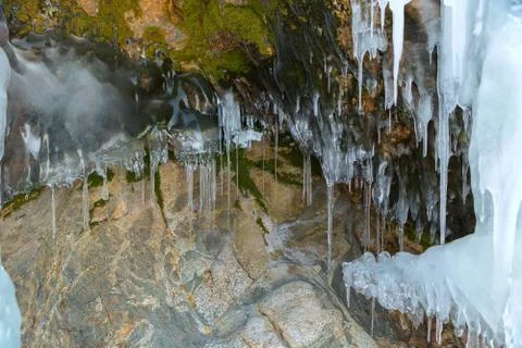 Huge icicles on a cliff 스톡 사진