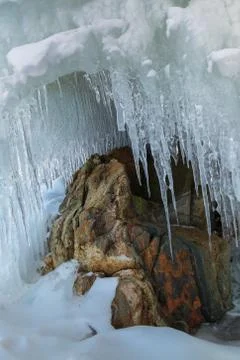 Huge icicles on a cliff Stock Photos