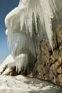 Huge icicles on rocks Stock Photos