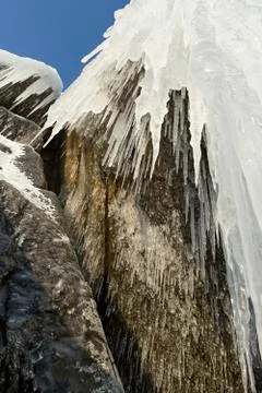 Huge icicles on rocks 스톡 사진