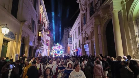 Huge illuminated party float with parade in a narrow street of Valletta during Stock Footage 304564117