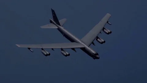 Huge Jet 8 engine B-52 Bomber escorted by fighter attack aircraft on both sides, Video stock 120368421