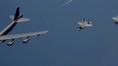 Huge Jet 8 engine B-52 Bomber escorted by fighter attack aircraft on both sides, Video stock 120368434