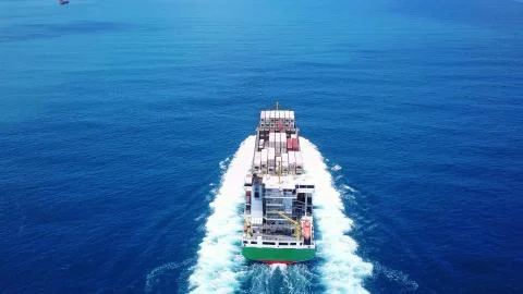 Huge large mega ULCV container ship sails on open water fully loaded Stock Photos