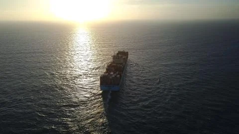 Huge large mega ULCV container ship sails on open water fully loaded Foto stock