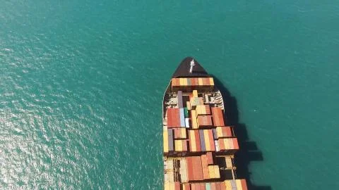 Huge large mega ULCV container ship sails on open water fully loaded Stock Photos