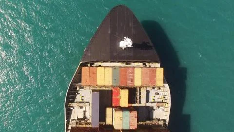 Huge large mega ULCV container ship sails on open water fully loaded Stock Photos