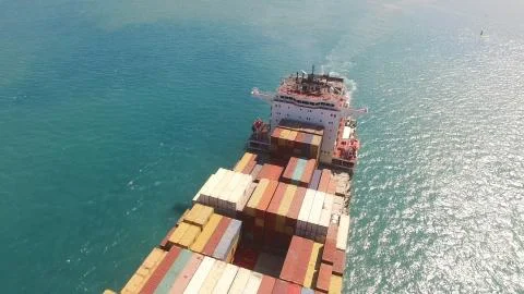 Huge large mega ULCV container ship sails on open water fully loaded Stock Photos