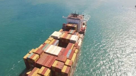 Huge large mega ULCV container ship sails on open water fully loaded Stock Photos