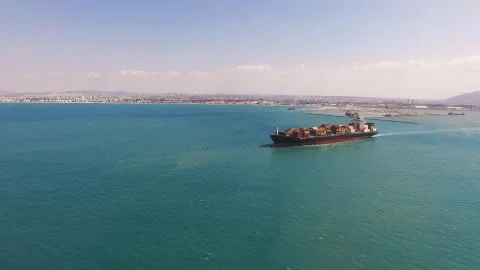 Huge large mega ULCV container ship sails on open water fully loaded Stock Photos