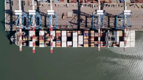 Huge large mega ULCV container ship sails on open water fully loaded Stock Photos