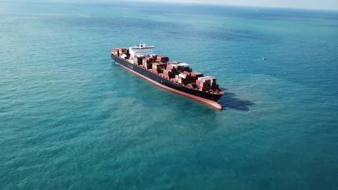 Huge large mega ULCV container ship sails on open water fully loaded Foto stock