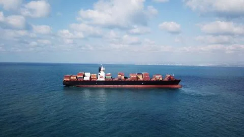 Huge large mega ULCV container ship sails on open water fully loaded Foto stock