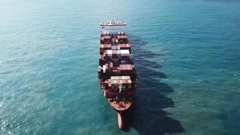 Huge large mega ULCV container ship sails on open water fully loaded Stock Photos
