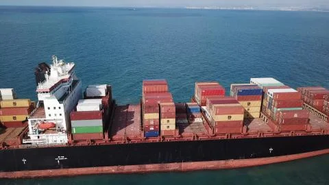 Huge large mega ULCV container ship sails on open water fully loaded Stock Photos