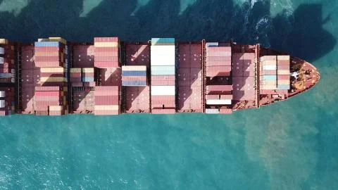Huge large mega ULCV container ship sails on open water fully loaded Stock Photos