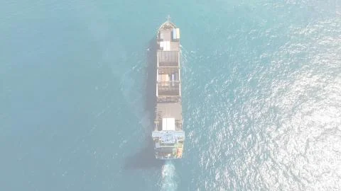 Huge large mega ULCV container ship sails on open water fully loaded Stock Photos