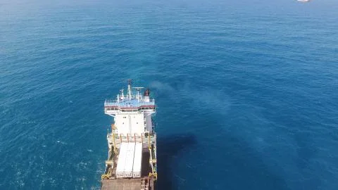Huge large mega ULCV container ship sails on open water fully loaded Stock Photos