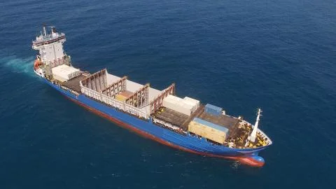 Huge large mega ULCV container ship sails on open water fully loaded Stock Photos