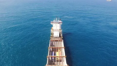 Huge large mega ULCV container ship sails on open water fully loaded Stock Photos
