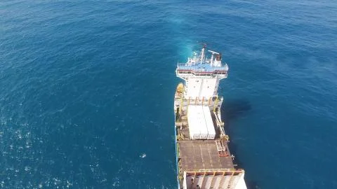 Huge large mega ULCV container ship sails on open water fully loaded Stock Photos