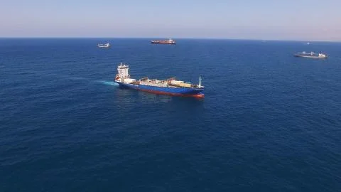 Huge large mega ULCV container ship sails on open water fully loaded Foto stock