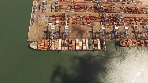 Huge large mega ULCV container ship sails on open water fully loaded Stock Photos