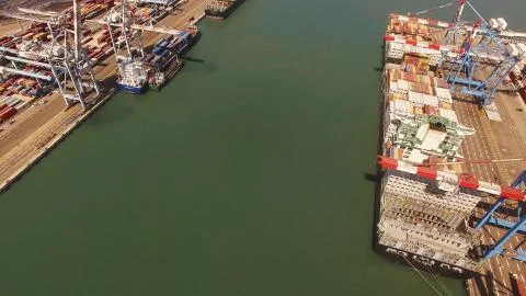 Huge large mega ULCV container ship sails on open water fully loaded Stock Photos