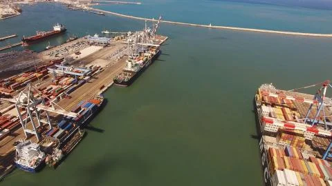 Huge large mega ULCV container ship sails on open water fully loaded Stock Photos