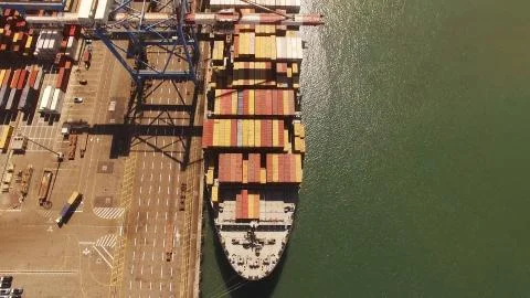 Huge large mega ULCV container ship sails on open water fully loaded Stock Photos