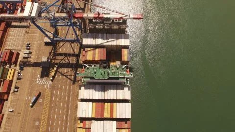Huge large mega ULCV container ship sails on open water fully loaded Stock Photos