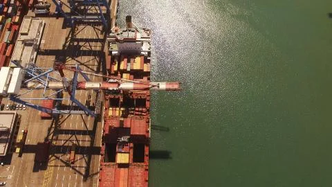 Huge large mega ULCV container ship sails on open water fully loaded Stock Photos