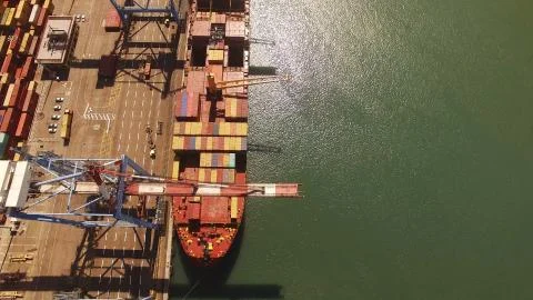 Huge large mega ULCV container ship sails on open water fully loaded Stock Photos