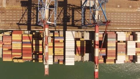 Huge large mega ULCV container ship sails on open water fully loaded Stock Photos