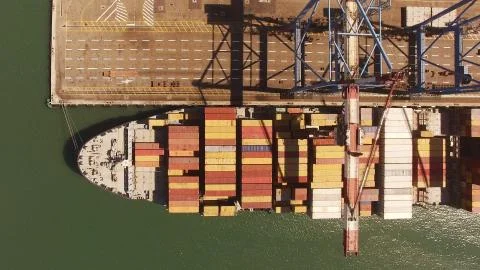 Huge large mega ULCV container ship sails on open water fully loaded Stock Photos