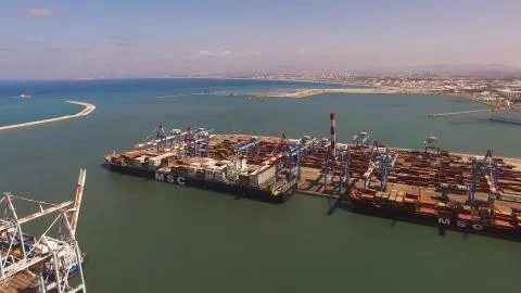 Huge large mega ULCV container ship sails on open water fully loaded Stock Photos