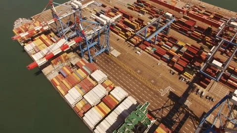 Huge large mega ULCV container ship sails on open water fully loaded Stock Photos