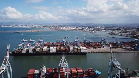 Huge large mega ULCV container ship sails on open water fully loaded Stock Photos