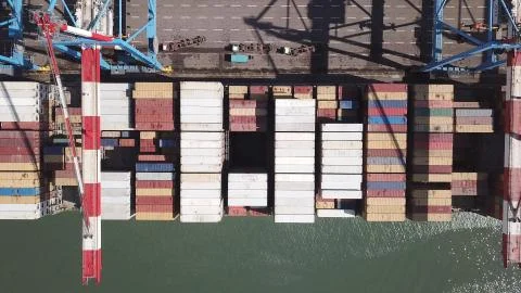 Huge large mega ULCV container ship sails on open water fully loaded Stock Photos